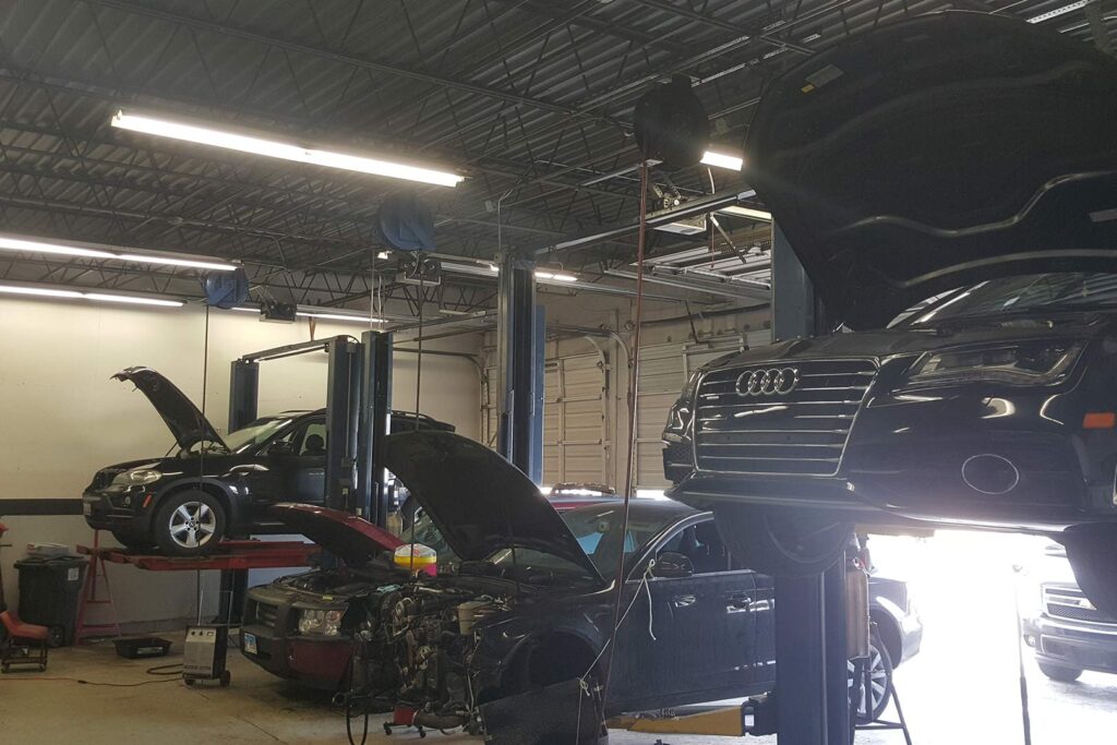 Vehicles undergoing maintenance in an auto repair shop.